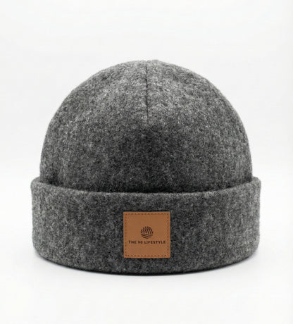 Gray sauna beanie with a brown leather patch on a white background